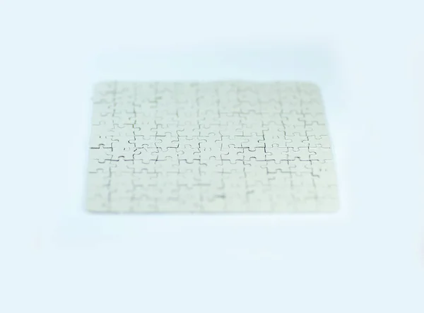 Close up. blank card collected from puzzle pieces on a white sheet — Stock Photo, Image