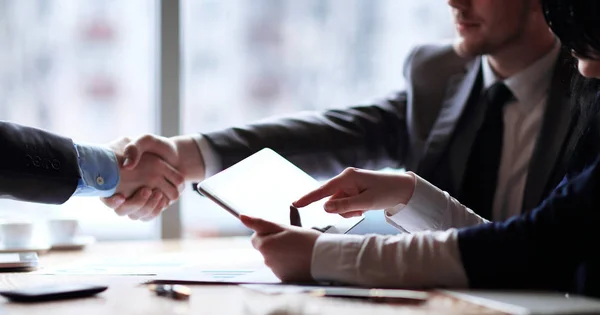 Businessman uses a digital tablet at a business meeting — Stock Photo, Image