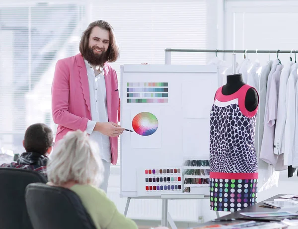Designer de moda mostrando aos colegas a paleta de cores para a nova coleção — Fotografia de Stock