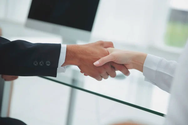 Closeup .the financial partners shaking hands over a Desk . — Stock Photo, Image