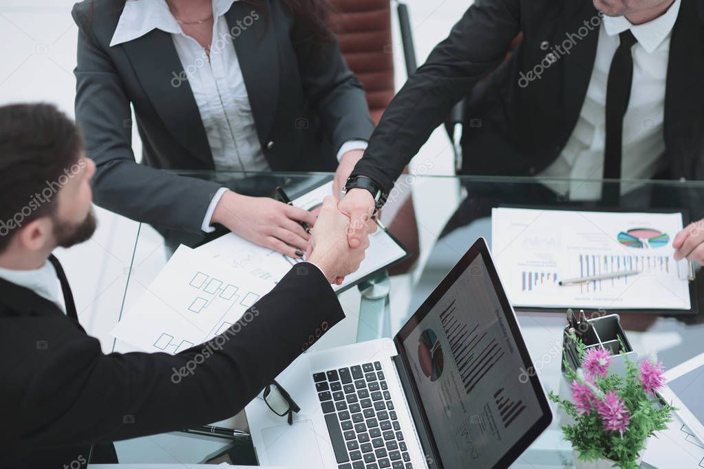 close up. handshake of trading partners at the negotiating table