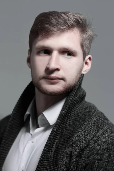Close up.a stylischer junger Mann in einem Strickjacken.isolated auf grauem Hintergrund — Stockfoto