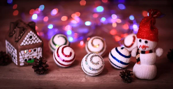 クリスマスボールとクリスマステーブルの上のおもちゃの雪だるま — ストック写真