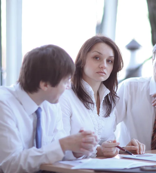 Business colleagues analyzing financial statistics sitting at a Desk — Stock Photo, Image