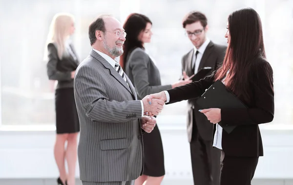 Assistente encontra um homem de negócios com um aperto de mão. reuniões e parceria — Fotografia de Stock