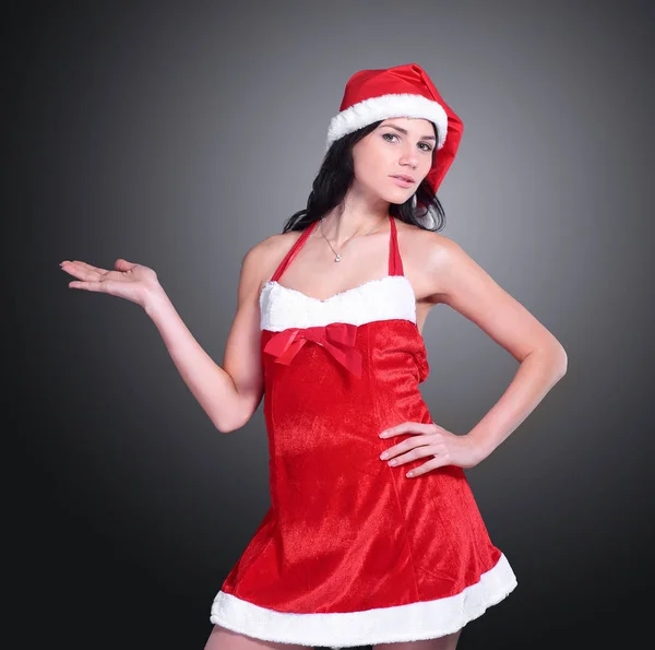 Confident young woman in costume of Santa Claus showing to copy — Stock Photo, Image