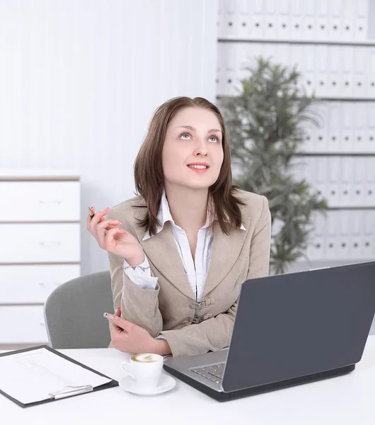 dreaming business woman sitting at her Desk