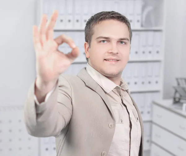 Portrait of a young businessman showing OK sign. — Stock Photo, Image