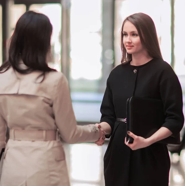 Handshake of the company manager and the client in the lobby of the modern office — Stock Photo, Image