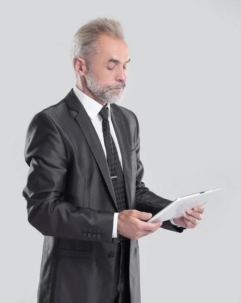 Modern businessman reading text on a digital tablet.isolated on grey background — Stock Photo, Image