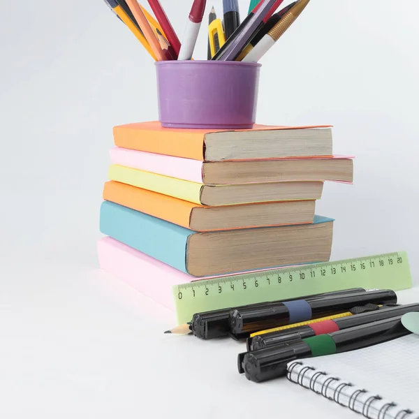 Books and a variety of office supplies on white background .phot — Stock Photo, Image