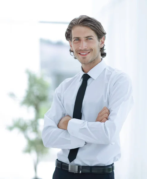 Serious young businessman on background of office — Stock Photo, Image