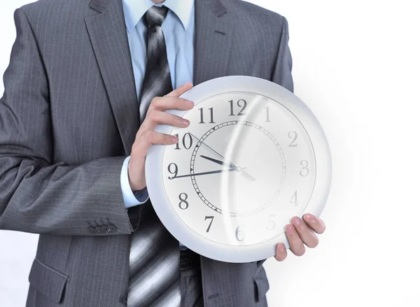Close-up.young businessman holding a clock. isolated on white — Stock Photo, Image