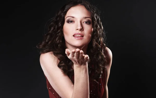 Closeup. portrait of beautiful woman in red dress sending a kiss. — Stock Photo, Image