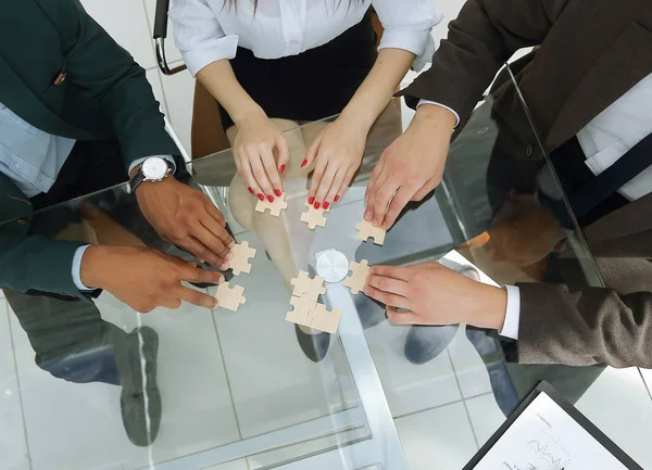 View from the top.business team folding puzzle pieces. — Stock Photo, Image