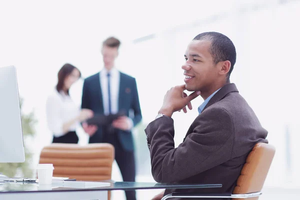 Confident young businessman on blurred background office — Stock Photo, Image