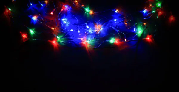 Garland with colorful lights on black background — Stock Photo, Image