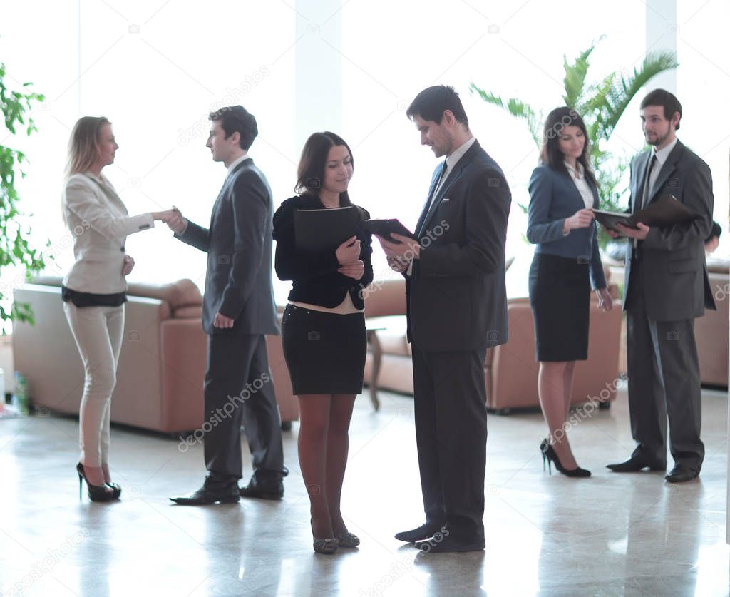 employees of the company before the meeting are in the lobby of the office