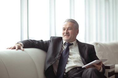 modern ofis kanepe üzerinde oturan başarılı iş adamı