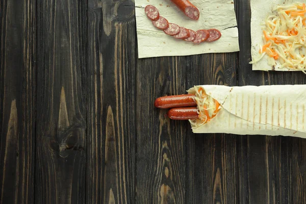 Close up. preparation of sausage in lavash .photo with copy spac — Stock Photo, Image