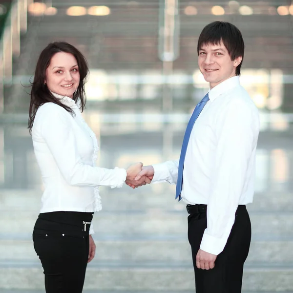 Vítejte handshake mladých obchodních partnerů na pozadí úřadu. — Stock fotografie