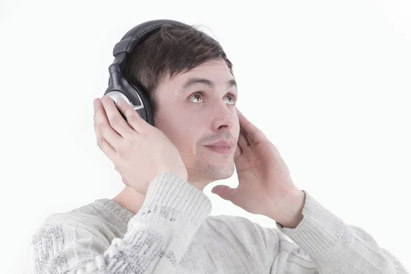 Closeup.modern boy listening to music through headphones. Royalty Free Stock Images