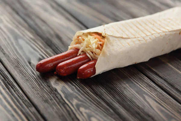 stock image German sausages in pita bread on a dark wooden background.photo 