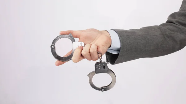 Close seup.business men holding a handcuffs . — стоковое фото