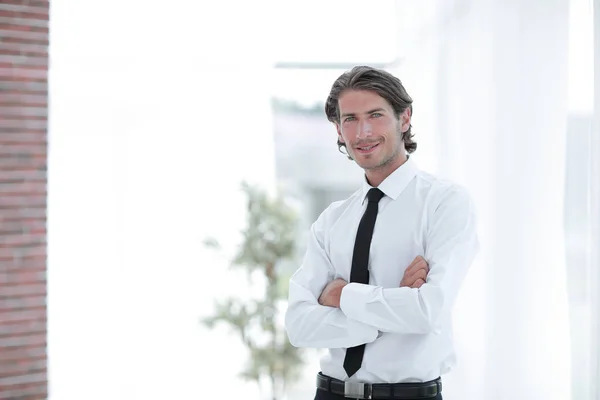 Serious young businessman on background of office — Stock Photo, Image