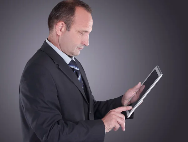 Modern businessman with a digital tablet.isolated on black background — Stock Photo, Image
