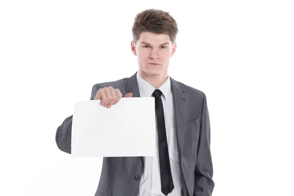 Ung affärsman visar ett tomt lakan isolerad på en vit — Stockfoto