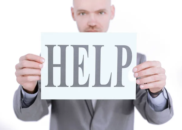 Confident businessman holding a banner with the word HELP — Stock Photo, Image