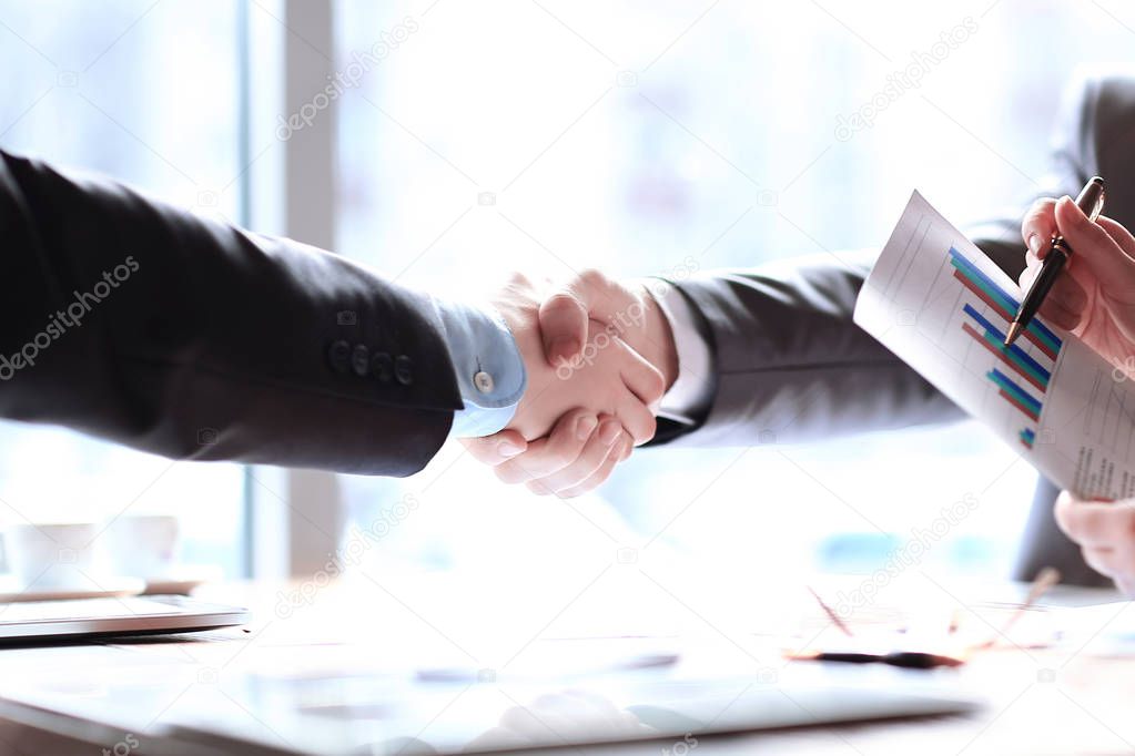 close up.handshake business partners at the office table