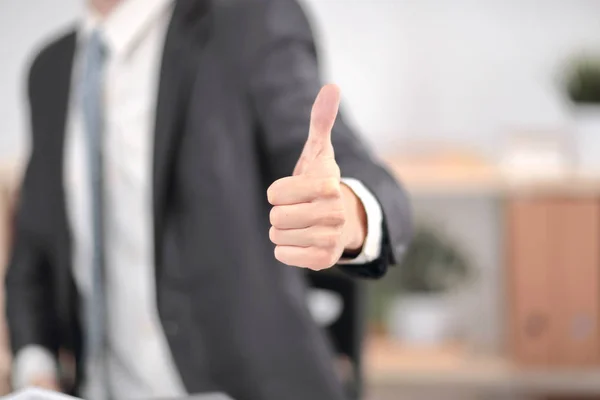 close up.Businessman showing thumb up. business concept