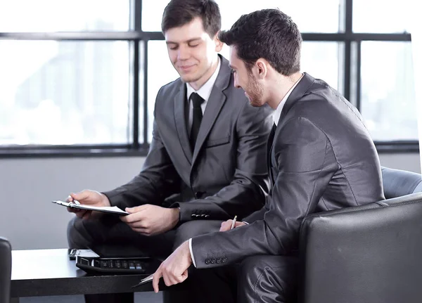 Boss with a clipboard , sitting in an office. photo with copy space — Stock Photo, Image