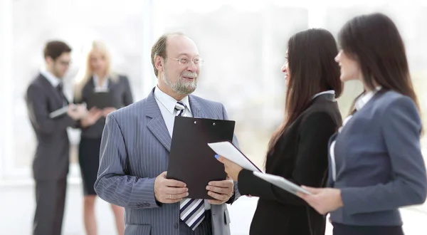 Close up .group of business people standing in lobby of office . — стоковое фото