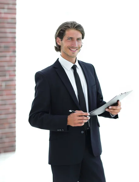 Businessman with business document standing in office — Stock Photo, Image