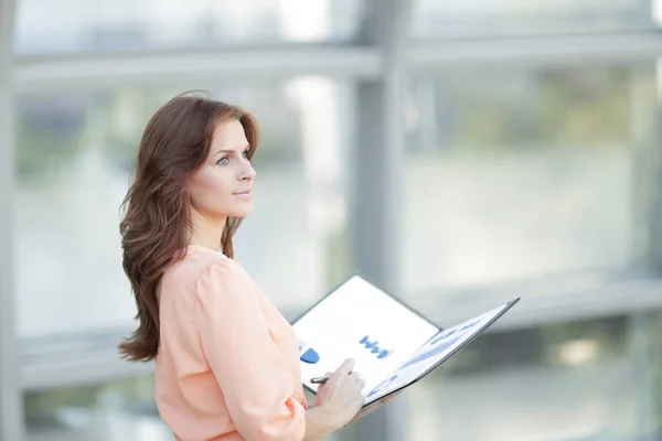 Rear view.a young business woman holds a folder with financial documents — Stock Photo, Image