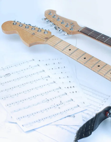 Closeup .sheet music and guitar on a white background. — Stock Photo, Image