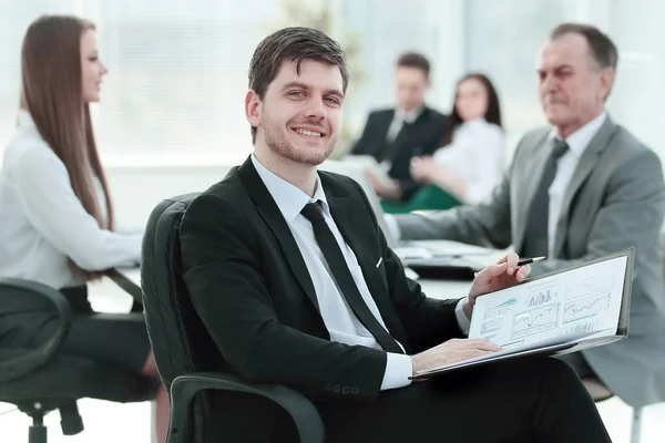 Business man at office with his business team working behind — Stock Photo, Image