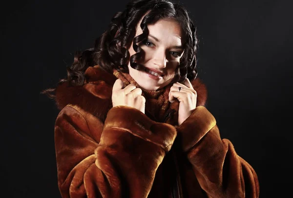 Portrait of beautiful young woman in red coat with evening makeup — Stock Photo, Image