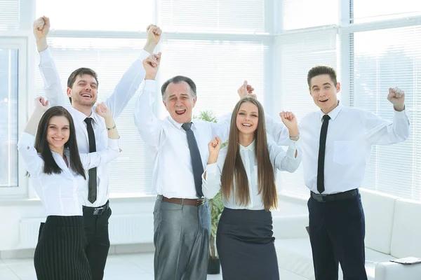 Group of happy young people in formal wear celebrating, gesturing, keeping arms raised — Stock Photo, Image