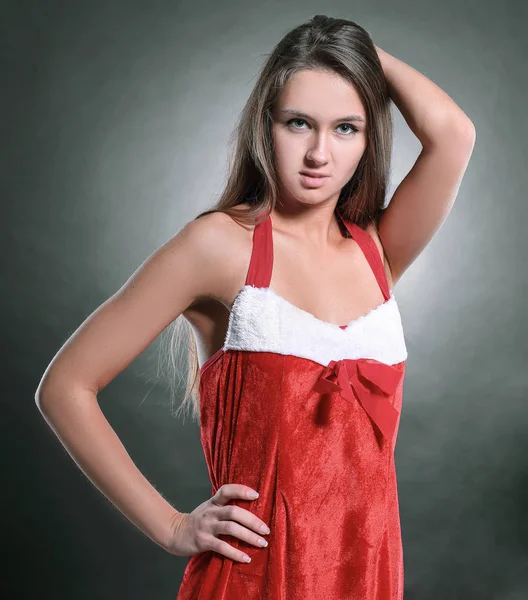 De jonge vrouw achter view.stylish in het kostuum van de kerstman op zoek — Stockfoto