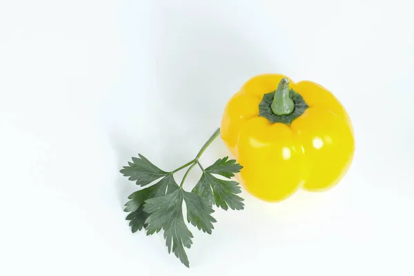 Yellow bell pepper, and a sprig of parsley .isolated on a white — Stock Photo, Image