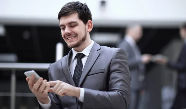 Portrait of handsome businessman on blurred office background — Stock Photo, Image