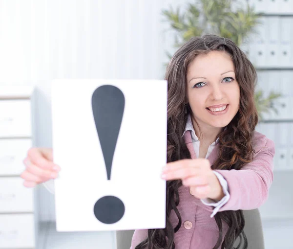 Young business woman showing poster with an exclamation point . — Stock Photo, Image