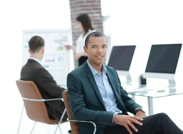 Successful businessman sitting at desktop in office. — Stock Photo, Image