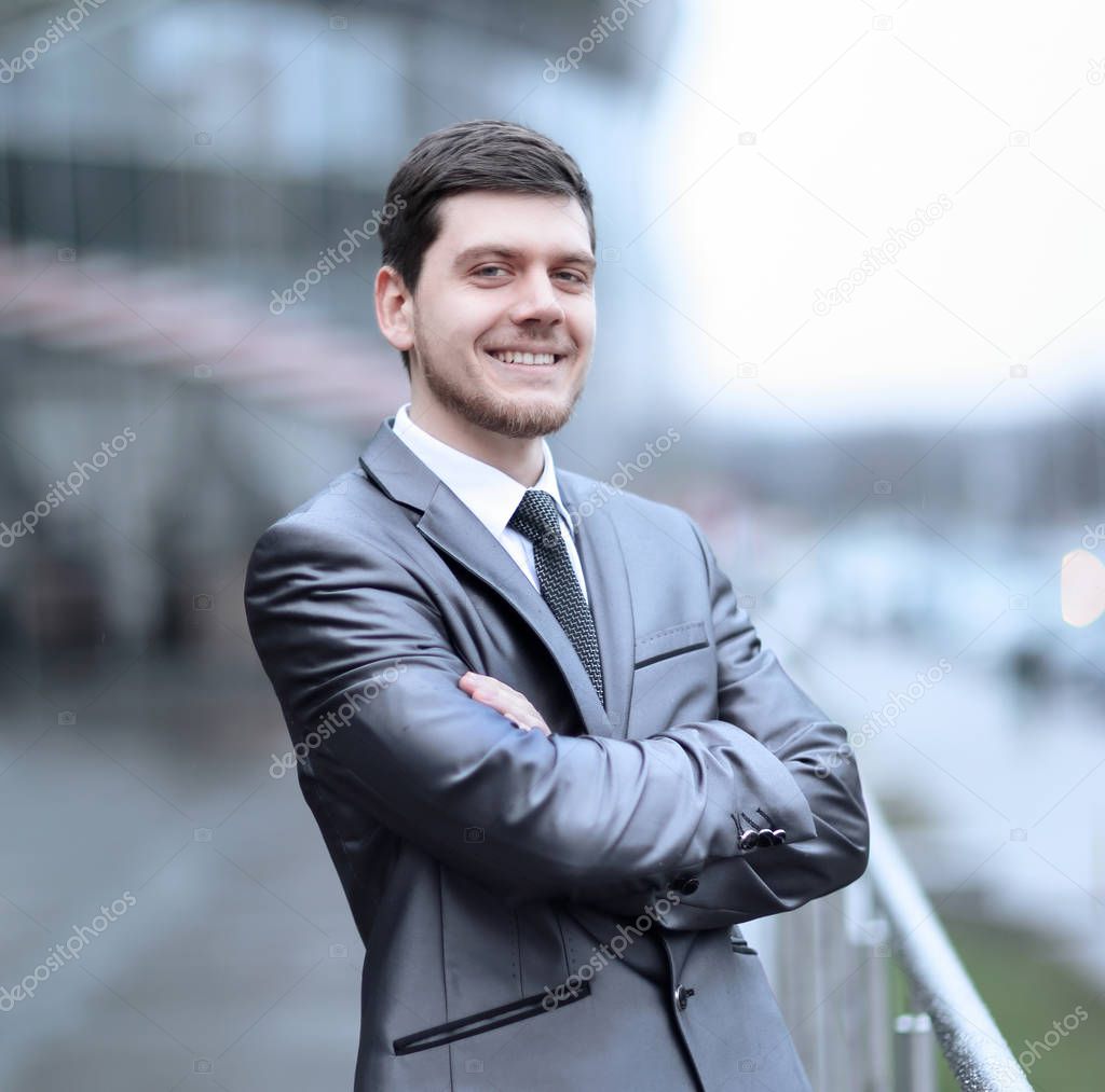 successful businessman standing on the balcony of the office
