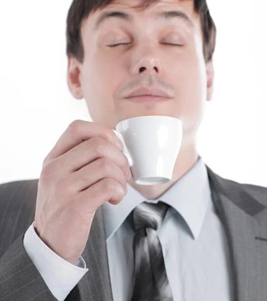 Closeup.hand some businessman inhaling the aroma of fresh coffee . — стоковое фото