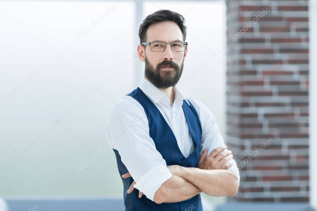 confident businessman standing in the office lobby.